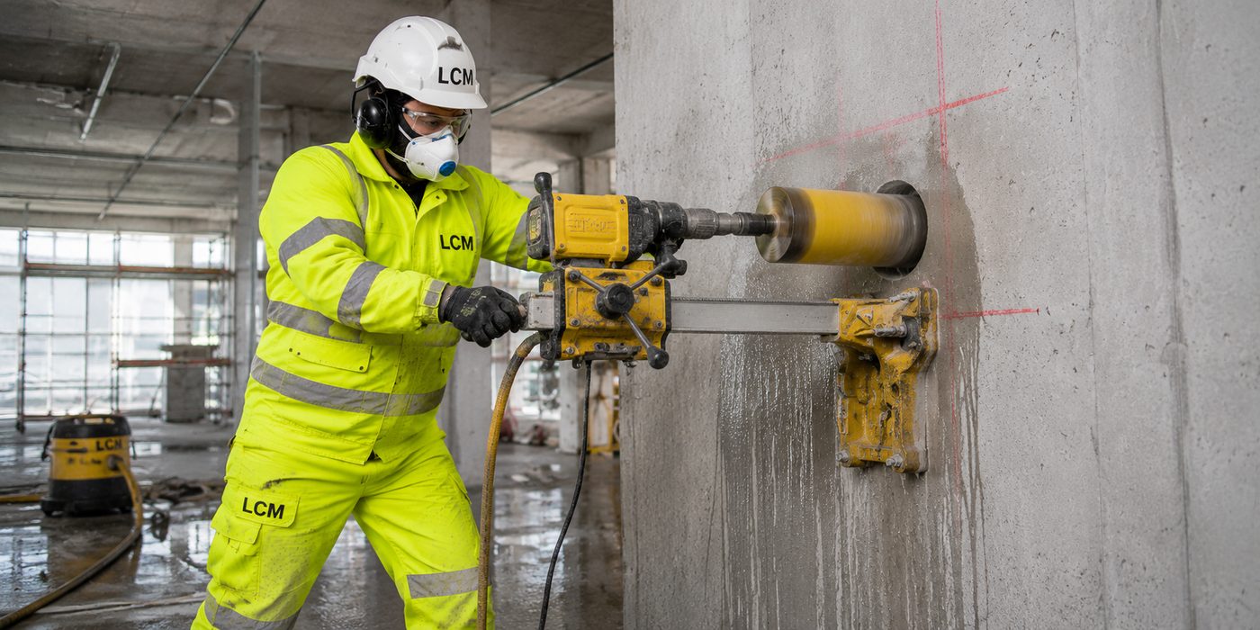LCM Ltd operative core drilling into a concrete column using a rig-mounted diamond drill.
