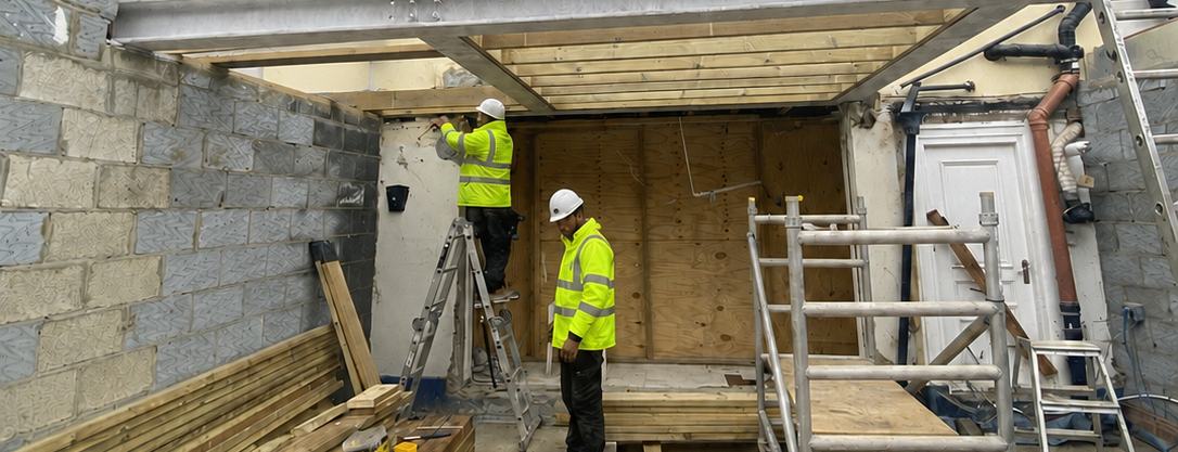 LCM Ltd operatives building a steel and timber extension frame at first-floor level on a London property.